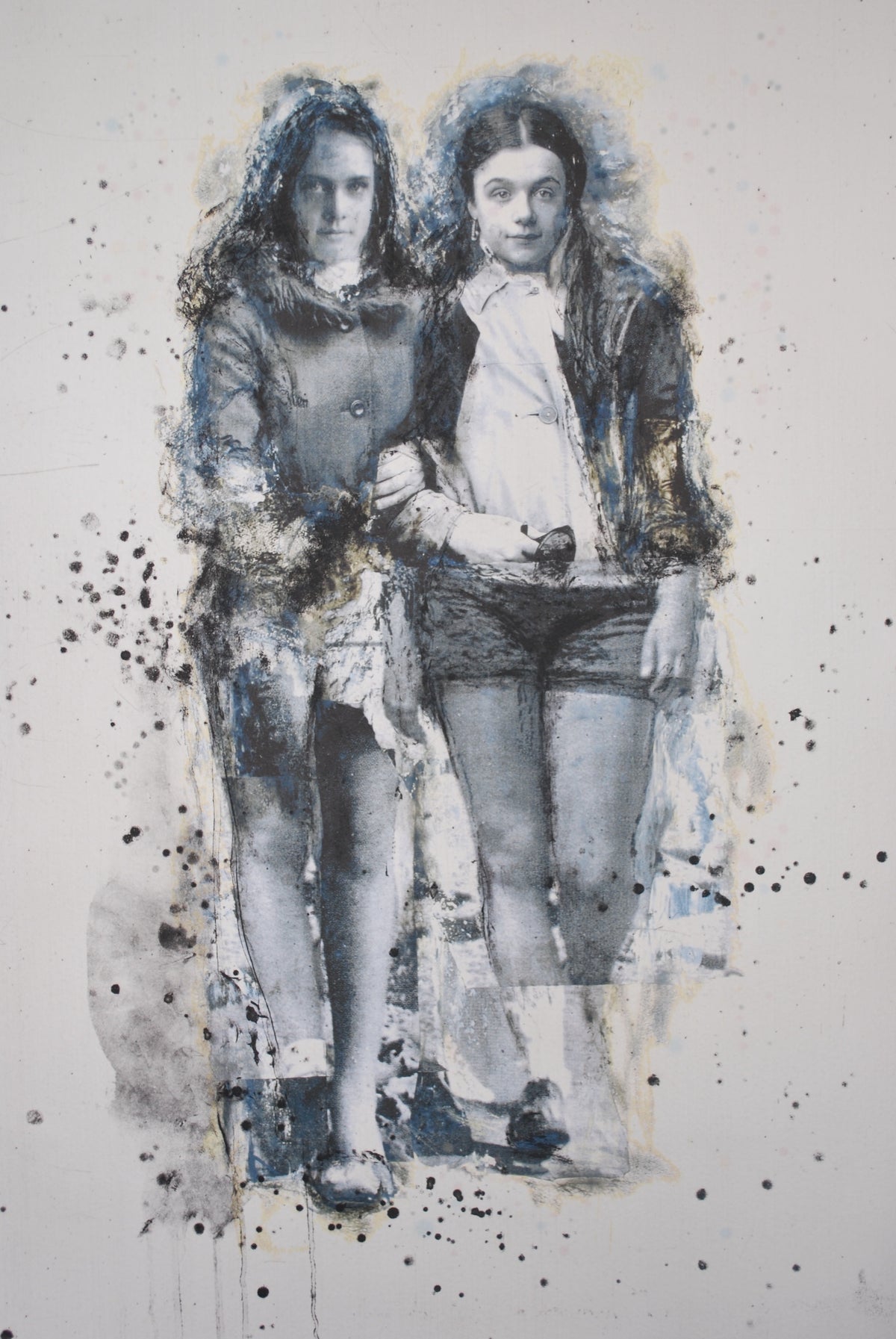 Angela Grossmann, Confetti, 2008. Two young girls standing next to each other, holding each other arm to arm - rendered in black and white with splashes of blue surrounding them.